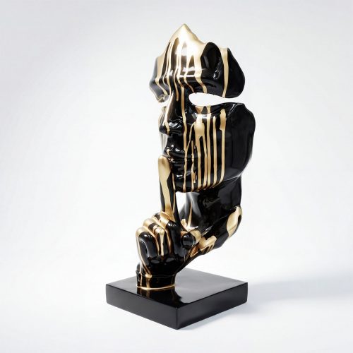 sculpture visage stylisé en fibre de verre noir et doré avec doigt sur les lèvres, style artistique décor événement boutique